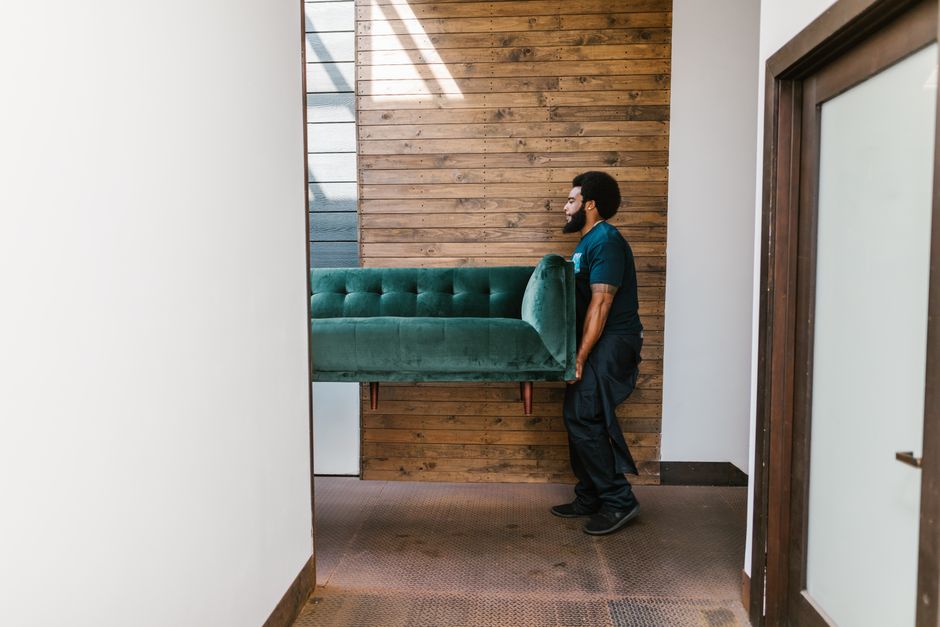 Movers carrying heavy furniture safely